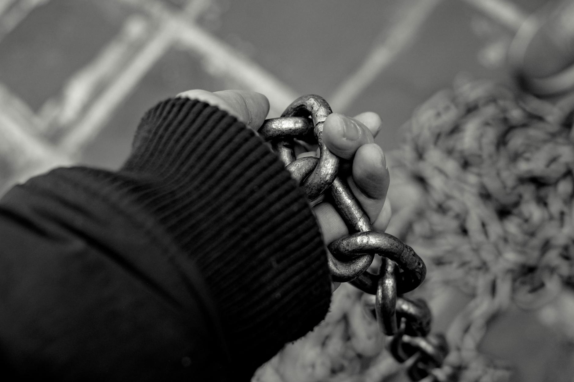 monochrome hand holding chain in turkiye